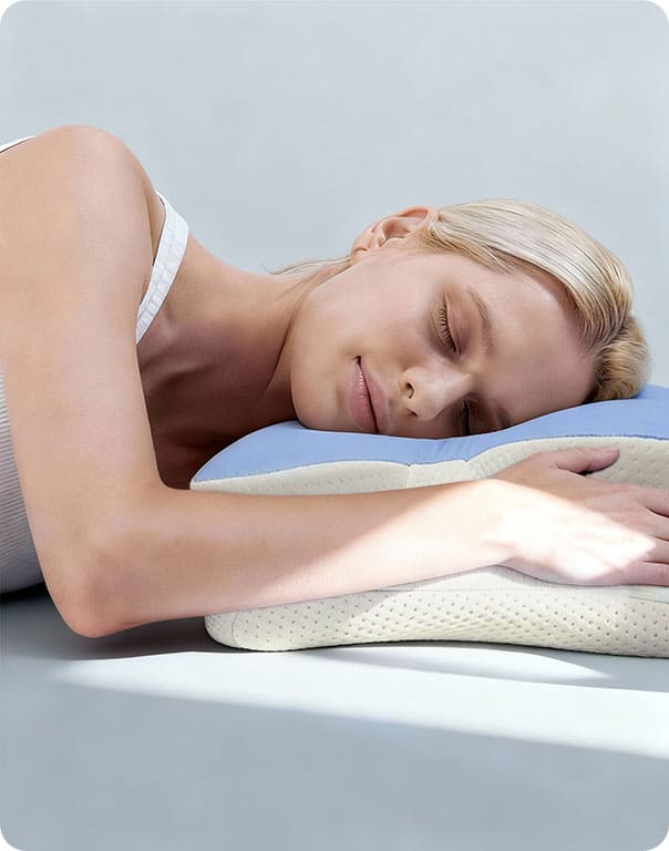 Side view of a person resting on a blue ergonomic pillow